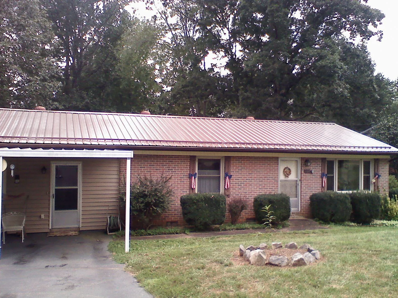 Bronze metal roof and carport on a brick ranch home — Roof Repair work by our crew in Sylmar