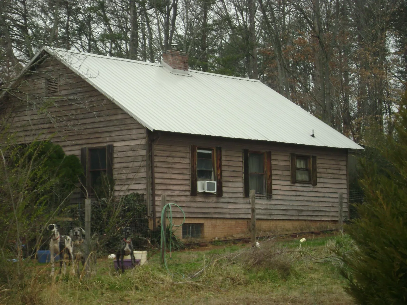 White metal roof on an old wood sided farmhouse, from a Asphalt Shingle Roof Repair job in Sylmar